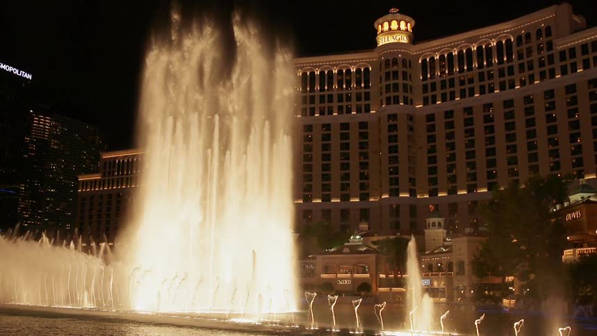 The founds spray high into the air in front of the building