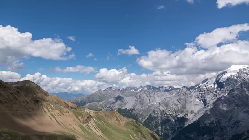 Timelapse of clouds moving fast over the mountains in the Alps