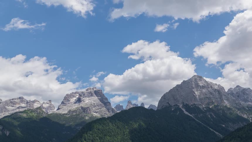 Clouds float over a Dolomites mountain range