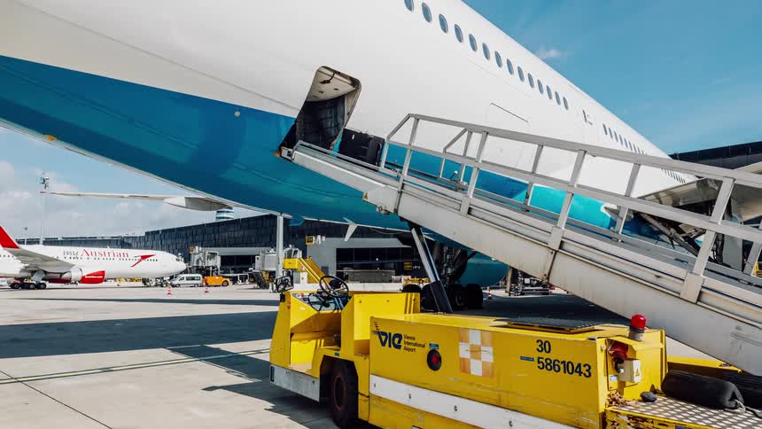 The luggage goes up the belt onto the plane