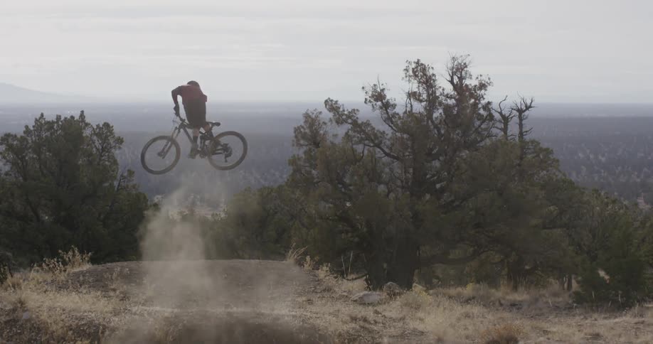 A person biking on a dusty hill