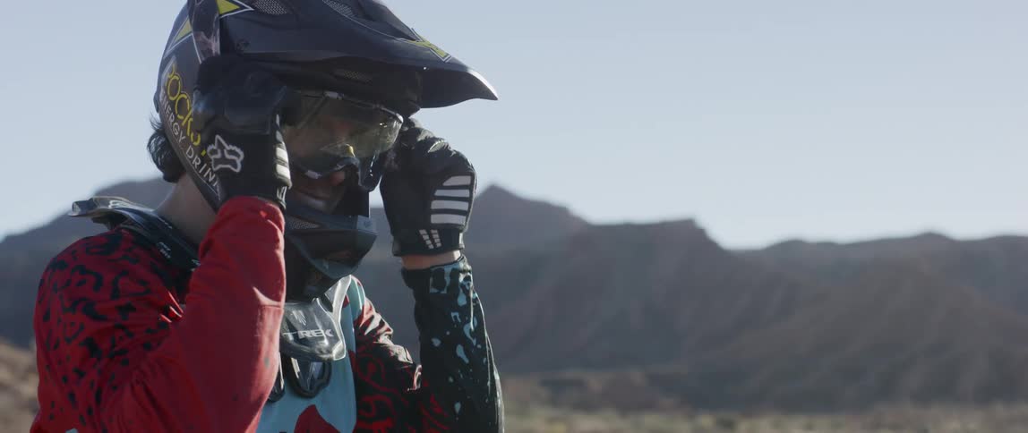 A man puts on goggles over his helmet