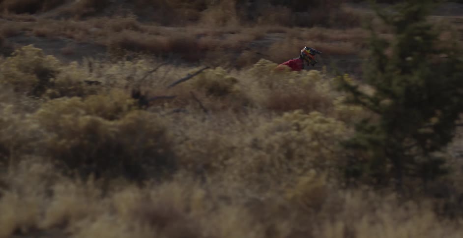 A person bikes off of a bridge