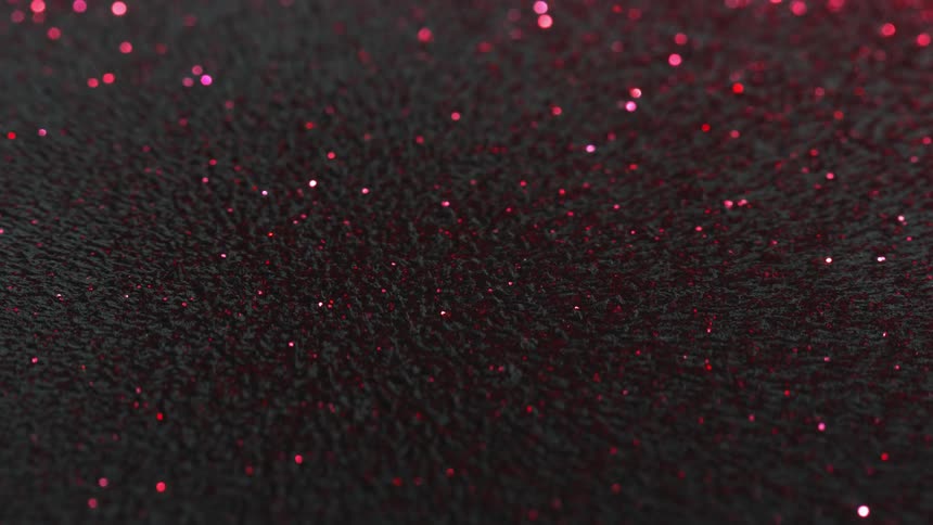 Pink and red glitter shines through gray magnetic fiber surface