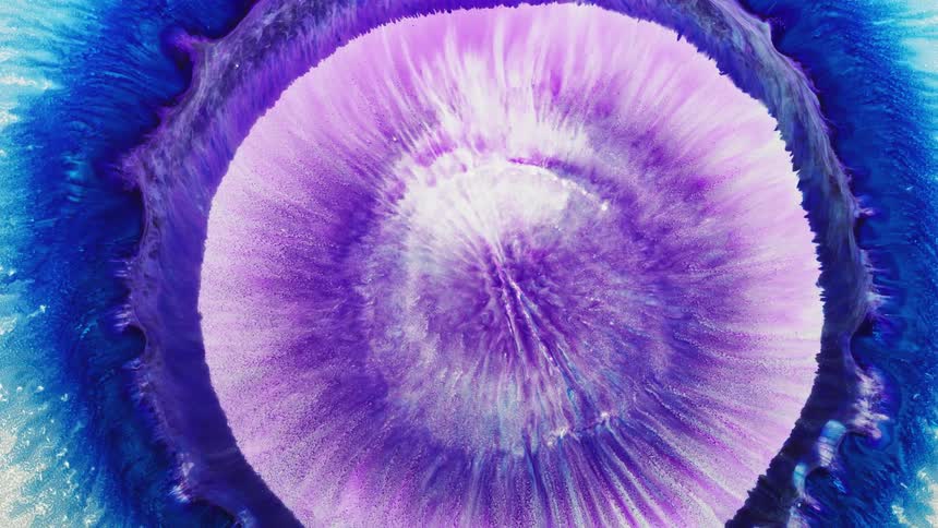 Colors and patterns are moving out from the center of a liquid body
