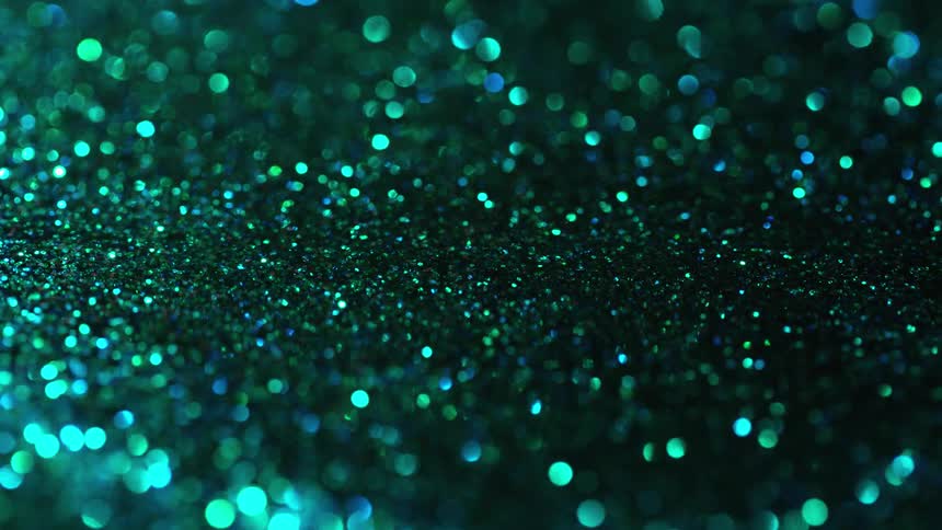 A granular substance sparkles as it flows and moves