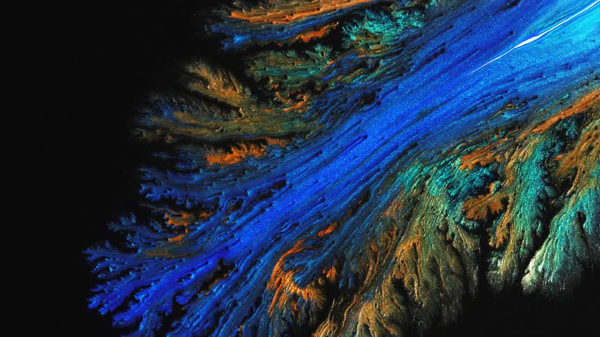 Glittery paint glistens and flows