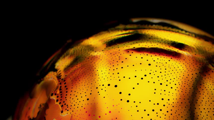 Blobs of yellow and bubbles expand over the green