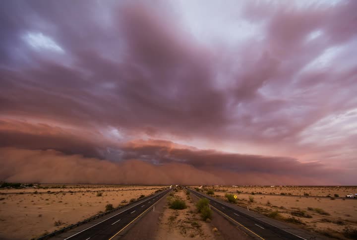 A desert storm approaches and engulfs a road