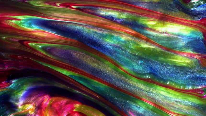 Multi-colored liquid rotates and swirls together