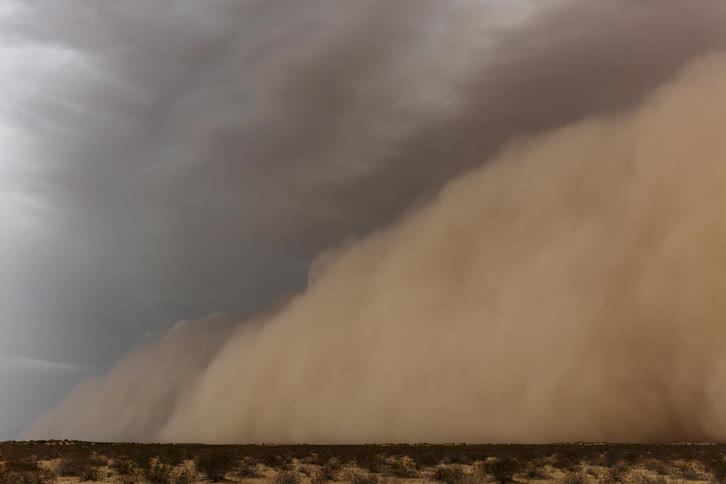 A dust storm covers the land
