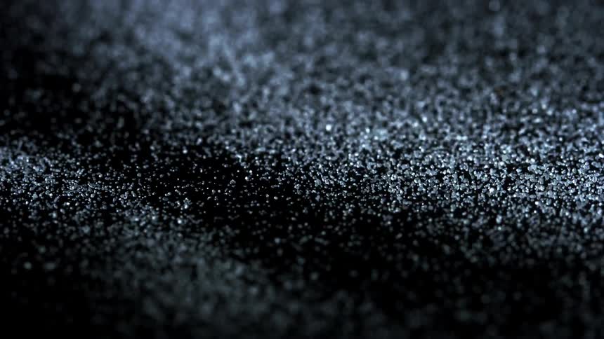Grains of gray and white vibrate and shift