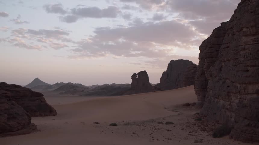 Clouds hang above the sandy landscape