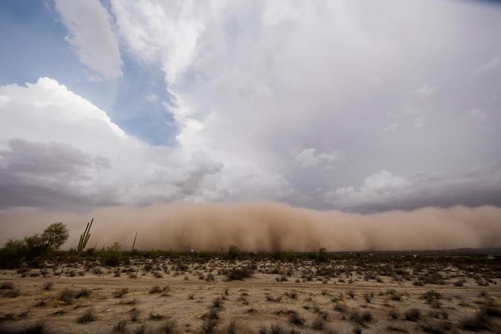 A dust storm approaches and engulfs a highway