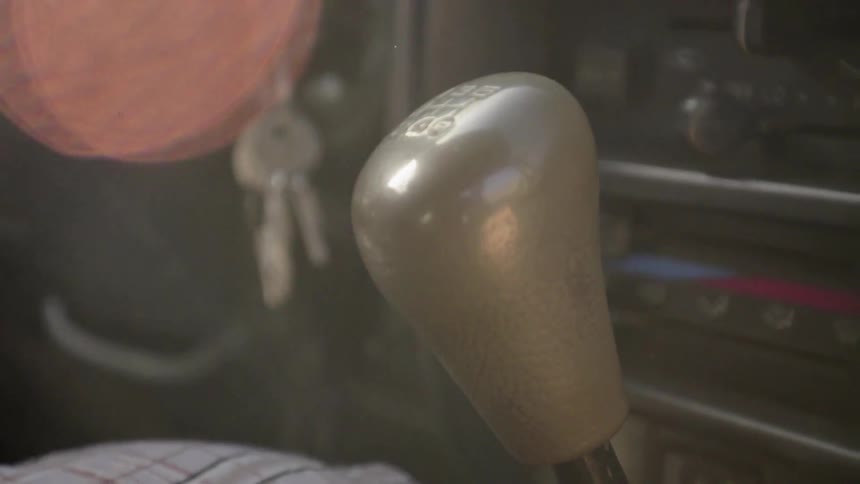 The stick shift in a car is vibrating as someone drives