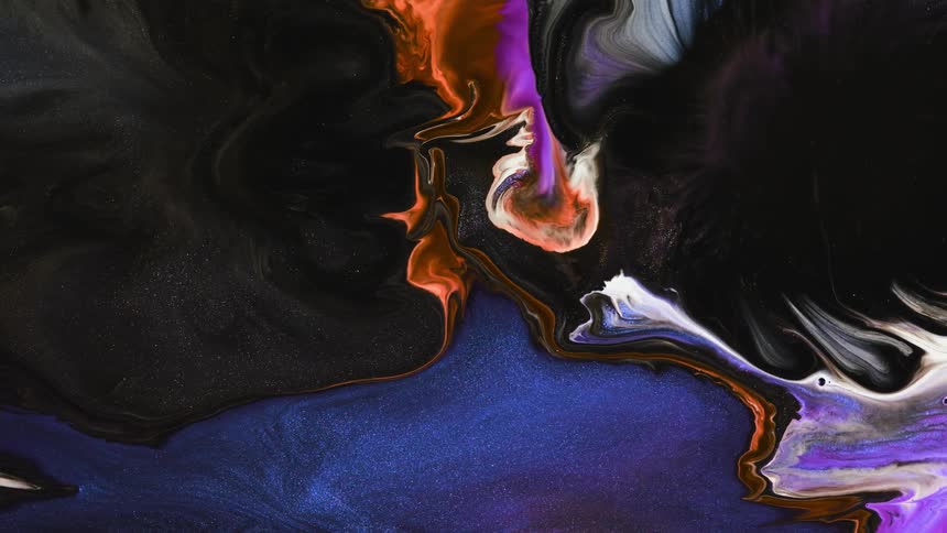 Multi-colored liquid rotates and swirls together