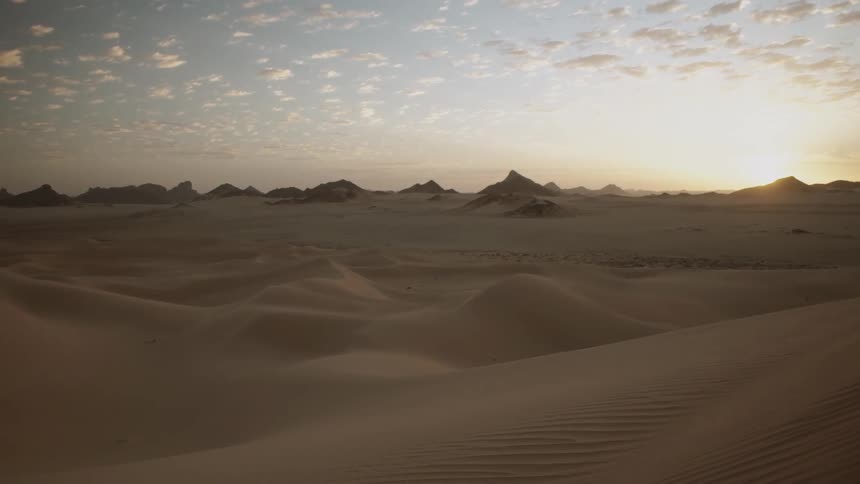 The sun shines on the desert landscape