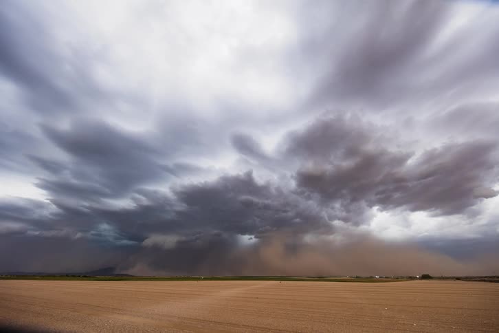 Clouds move over the land as a dust storm covers everything