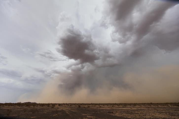 Storm clouds gather and a dust storm moves over the land