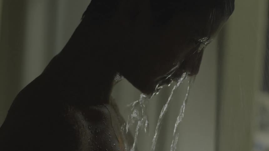 Water pouring over a mans head