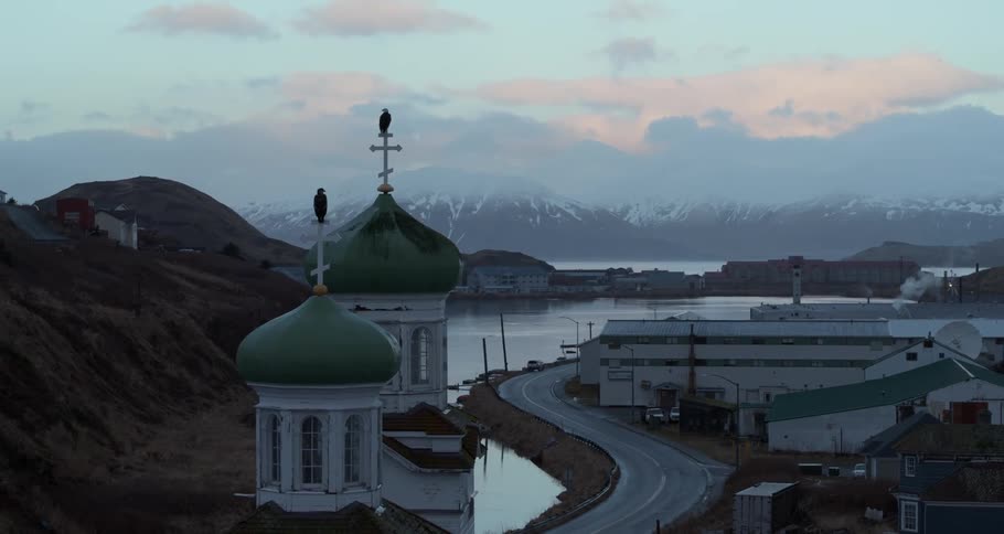 Birds are perched on top of church steeple at the harbor