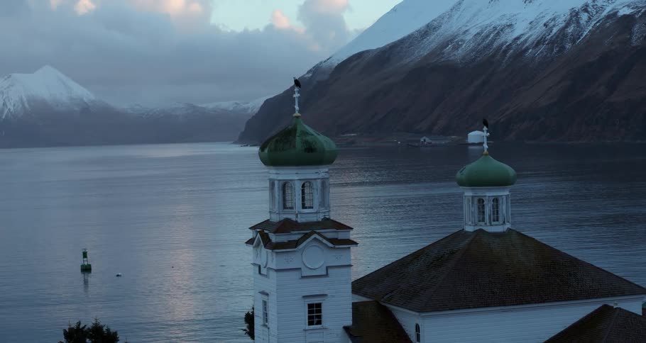 Eagles sit perched on an oceanside church