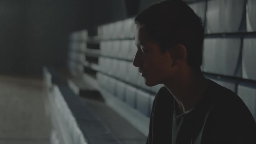 A person sitting on bleachers