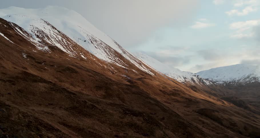 Clouds are drifting over a mountain range in winter