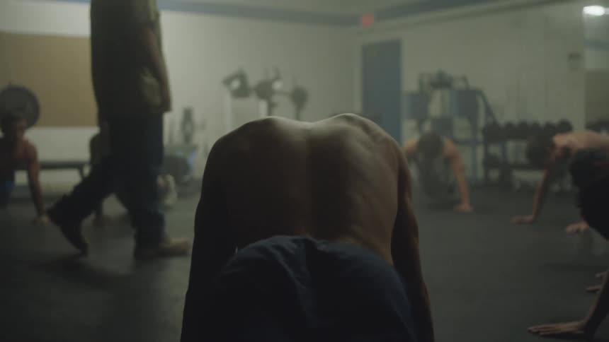 Group of men doing push ups in a gym