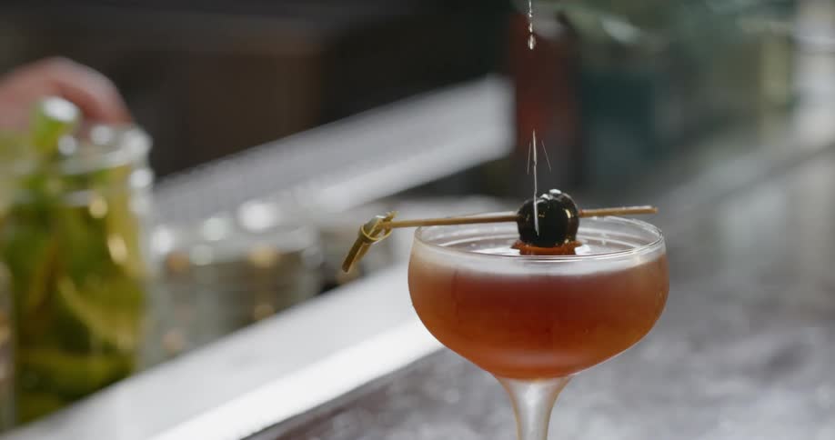 A bartender pours an alcoholic beverage