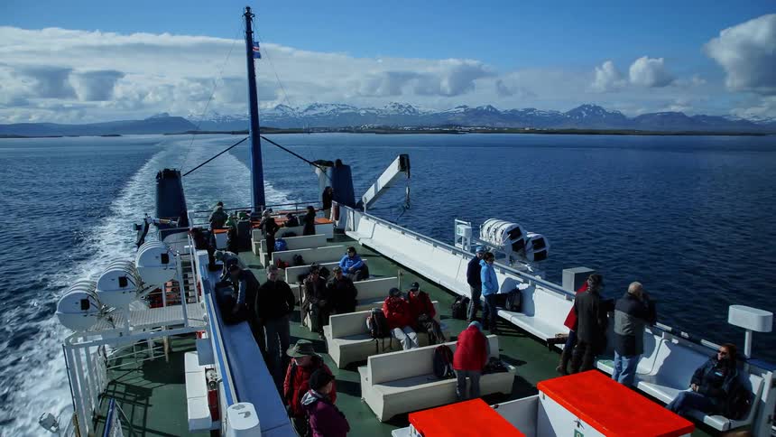People ride a ferry boat on the water