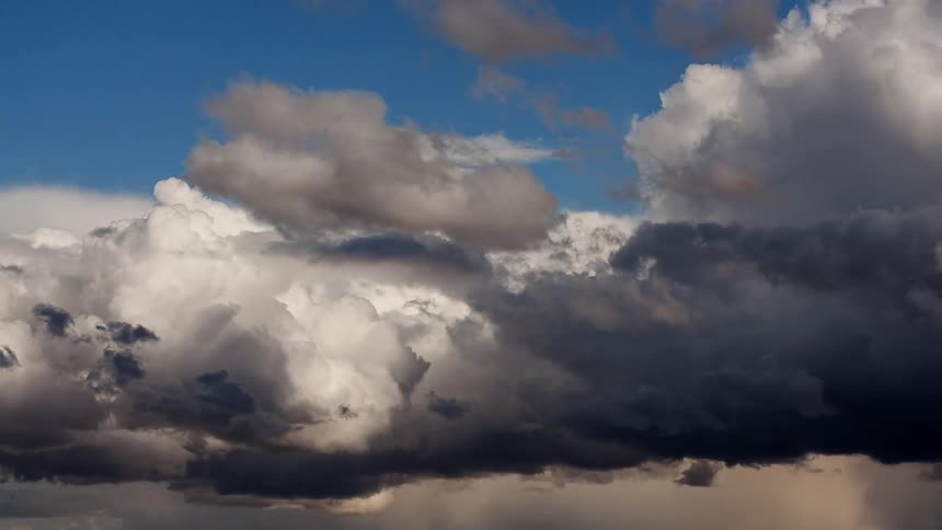 White and grey clouds flow into the sky