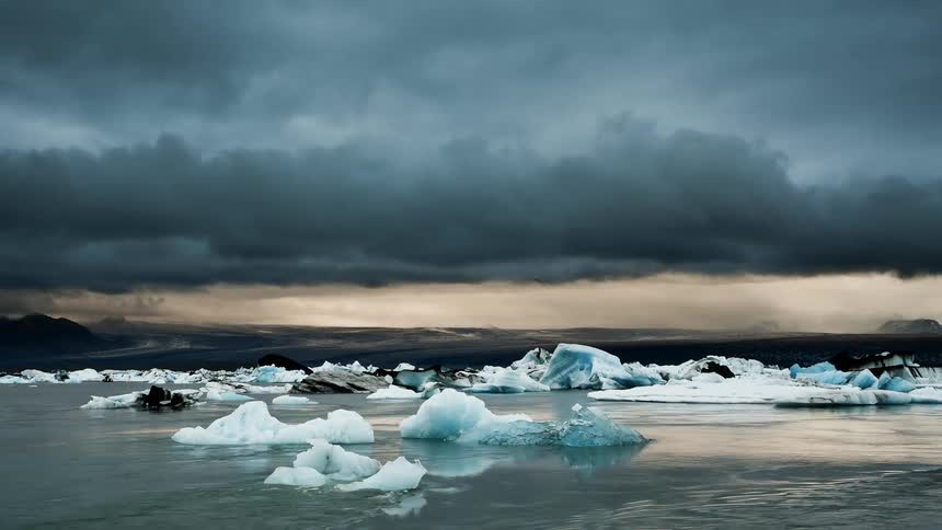 Clouds float over an icy lake
