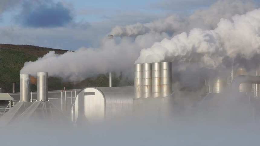 Smoke billows out of the building smokestacks