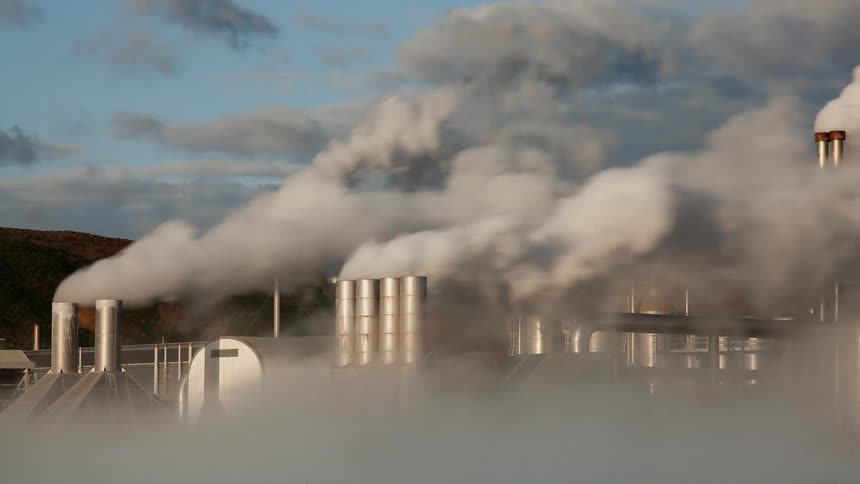 Smoke pours from smoke stacks