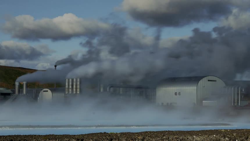 Smoke rises from factory smokestacks