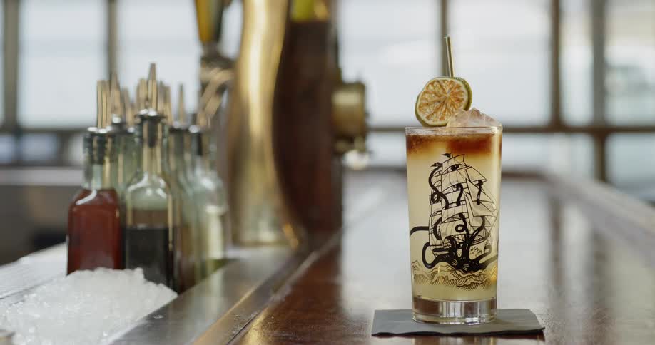 A cocktail sits on a bar counter