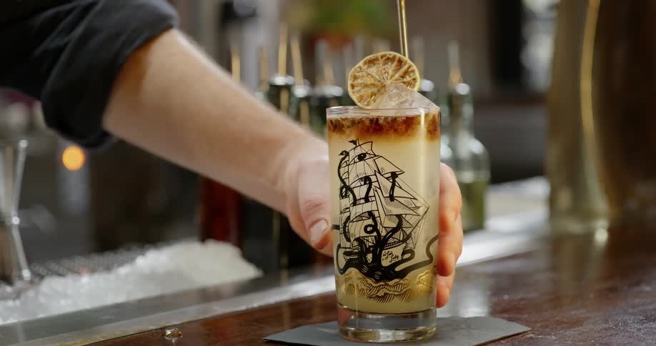 A bartender serves up an alcoholic beverage