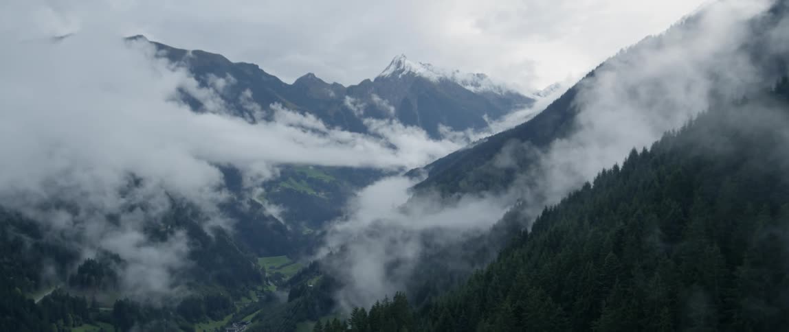 Snow falls in the mountains
