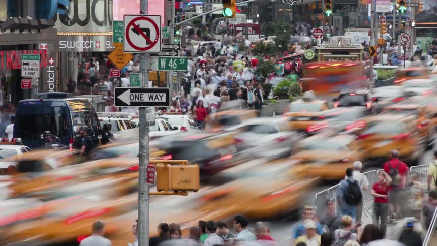 Time-lapse of people and traffic moving through a large city