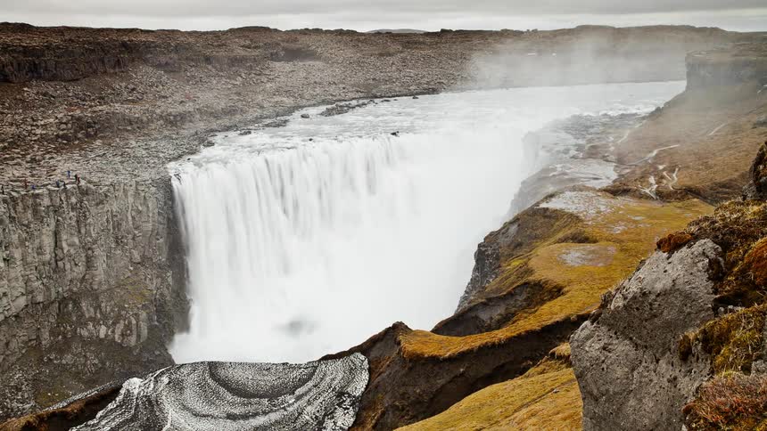 People are observing a waterfall as it flows throughout the day