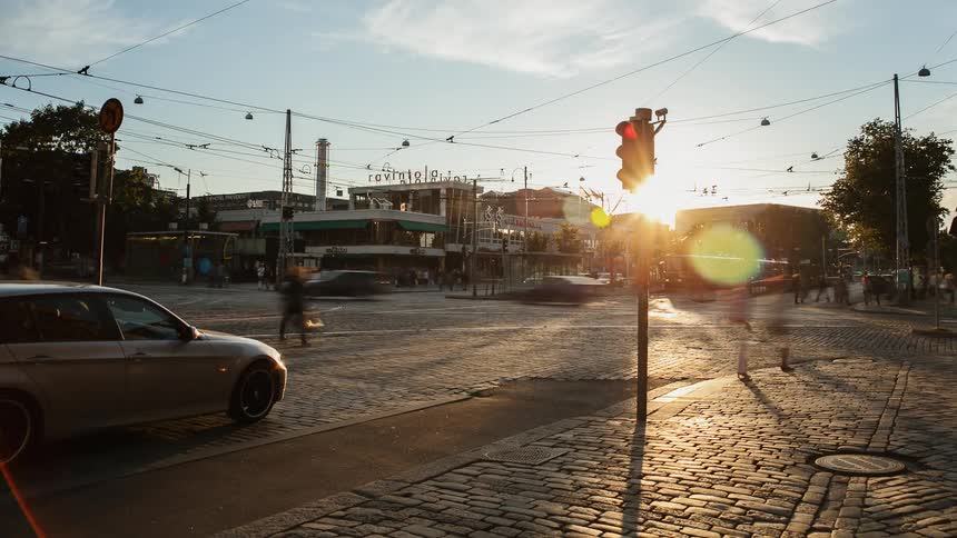 Pedestrians and cars travel in a city