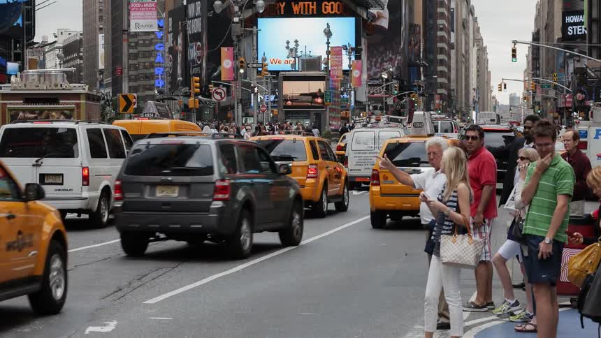 Time-lapse of people and traffic moving through a large city