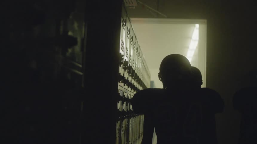 Player walks past some lockers in uniform