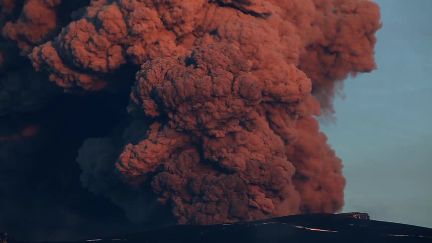 Huge clouds of brown smoke rising on a horizon