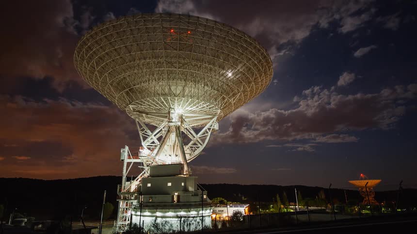 The radio dish at an observatory rotates during the night