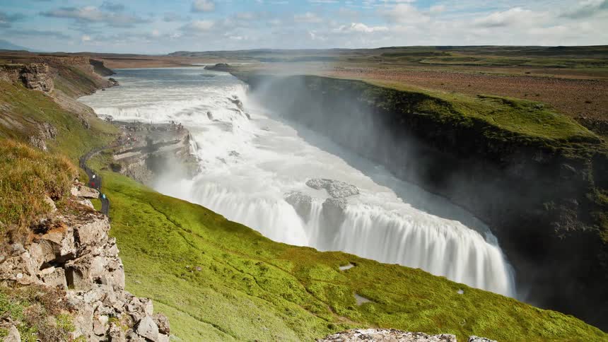 Steam rises from a waterfall