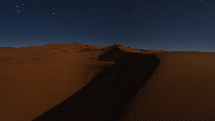 Stars swirl in a desert night sky