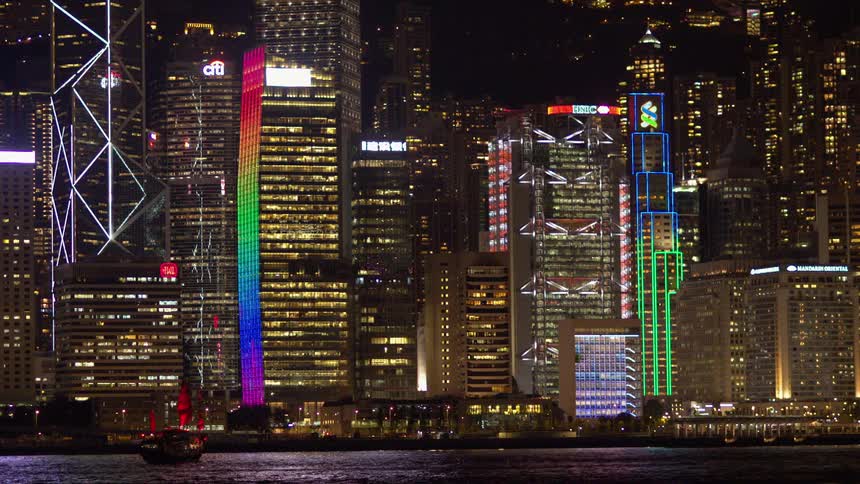 Lights shine on skyscrapers at night