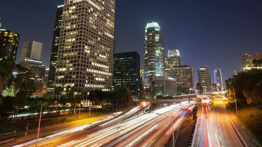 Time-lapse of traffic moving through a large city on an early evening